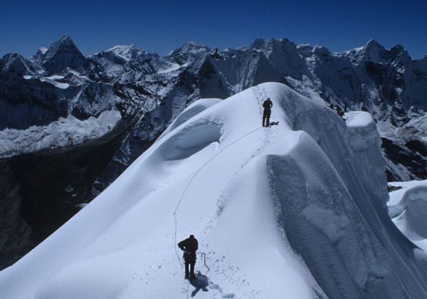 View from the Island Peak Climbing in Nepal, with snow-covered ridges and towering Himalayan mountains in the distance.