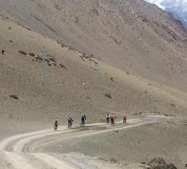 A distant view of a group of riders biking along a scenic trail in upper mustang trek.