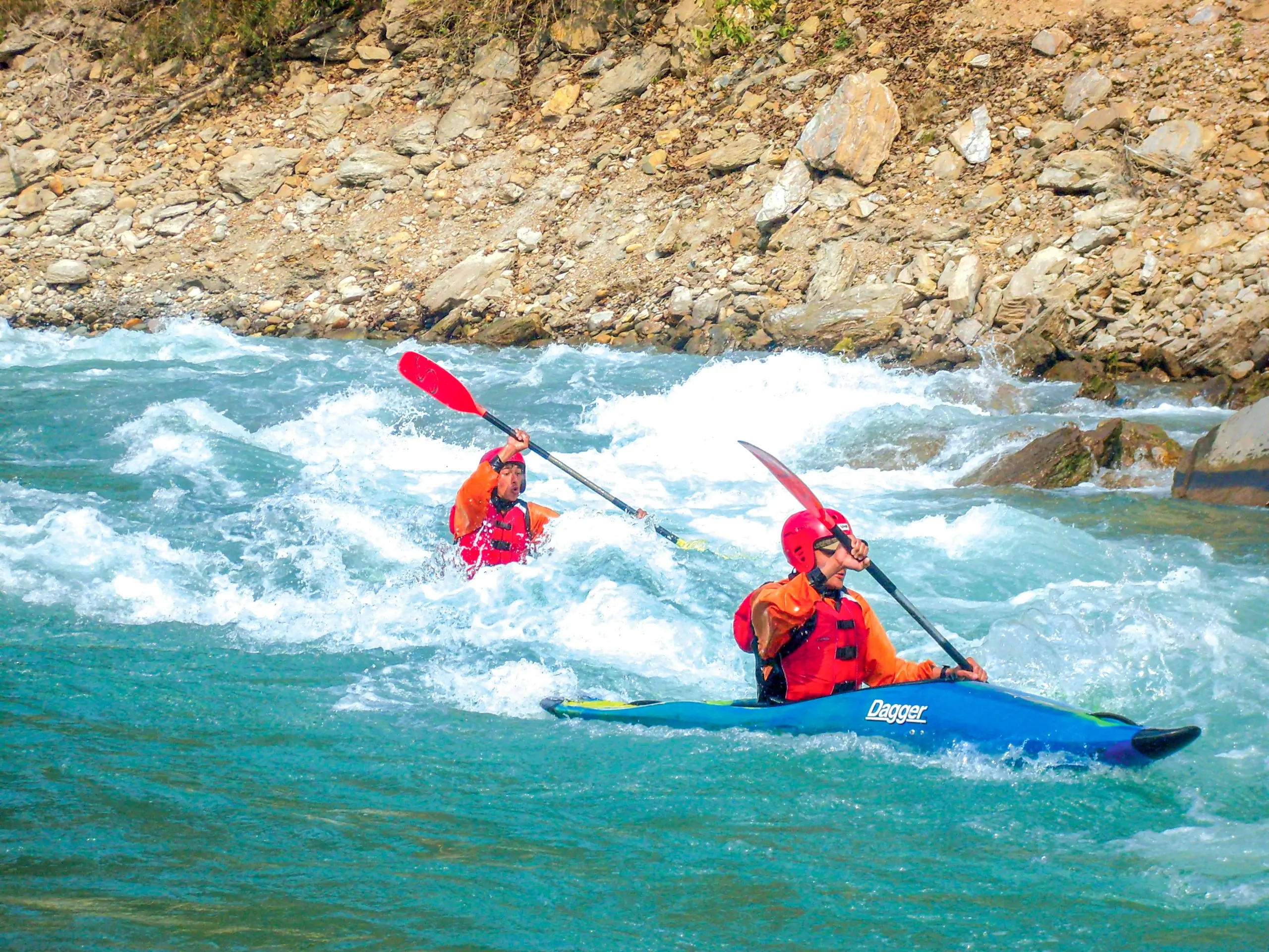 Two people paddling kayaks in kali gandaki river. Solo kayaking.