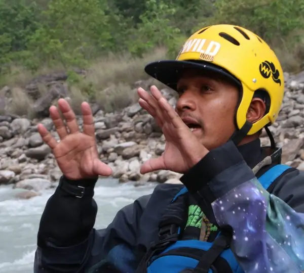 Instructor conducting a river guide assessment and training session outdoors, teaching rafting safety and techniques.