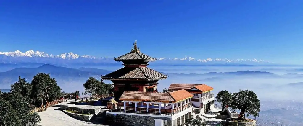 Chandragiri Temple perched on a hilltop with the Himalayan mountain range visible in the background on a clear day in Nepal.