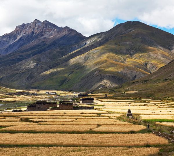 Vast panoramic view of Lower Dolpo Valley with rugged mountains and traditional villages nestled in the Himalayas of Nepal.