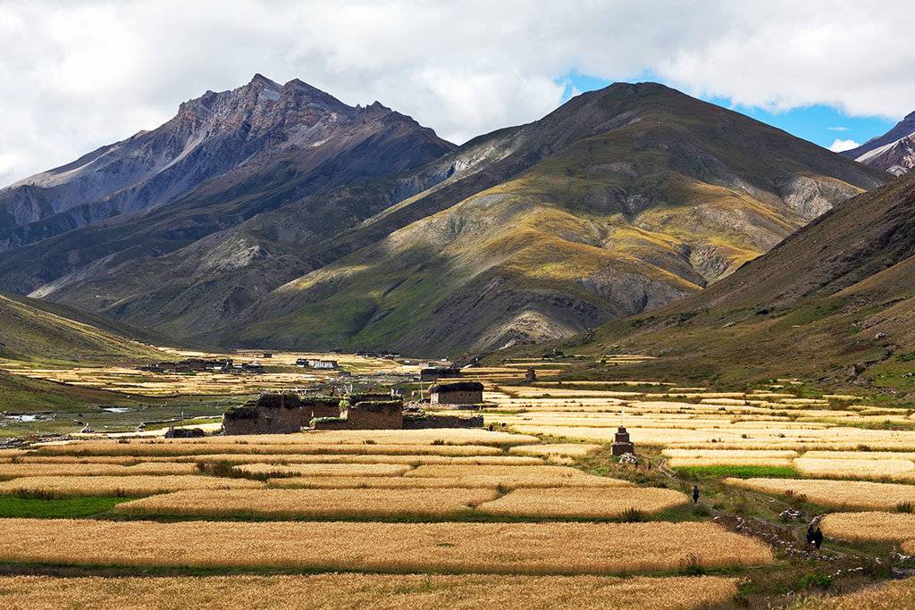 Vast panoramic view of Lower Dolpo Valley with rugged mountains and traditional villages nestled in the Himalayas of Nepal.