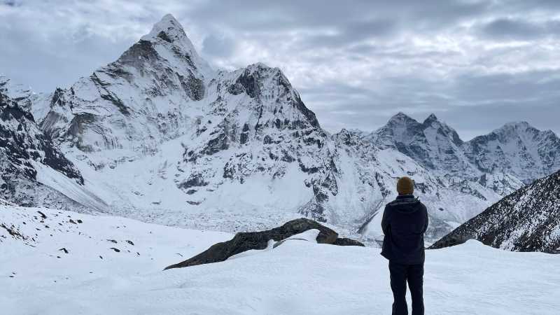Man enjoying the Everest view while trekking in Nepal during winter